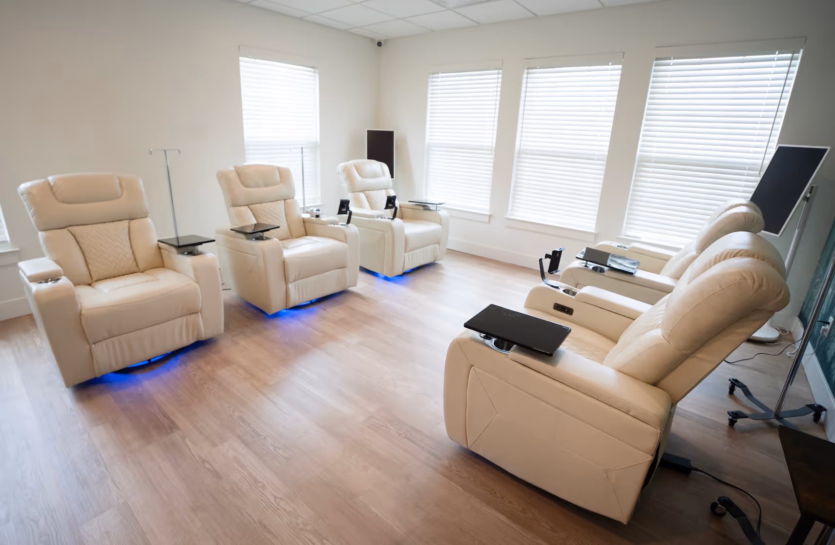 Four cream recliners lined up along the windows of the Nova IV Lounge